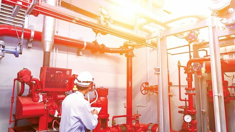 Engineer check red generator pump for water sprinkler piping and fire alarm control system